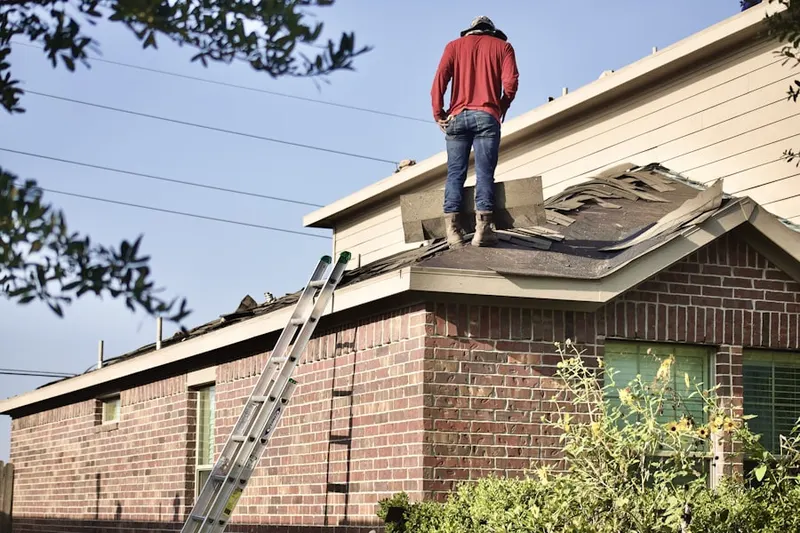 Professional roofer working on a residential roof in Stockdale